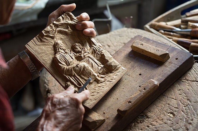 Patana carves scenes, often from Christian stories, into wood; a skill he was taught by another patient at the McKean Rehabilitation Center.