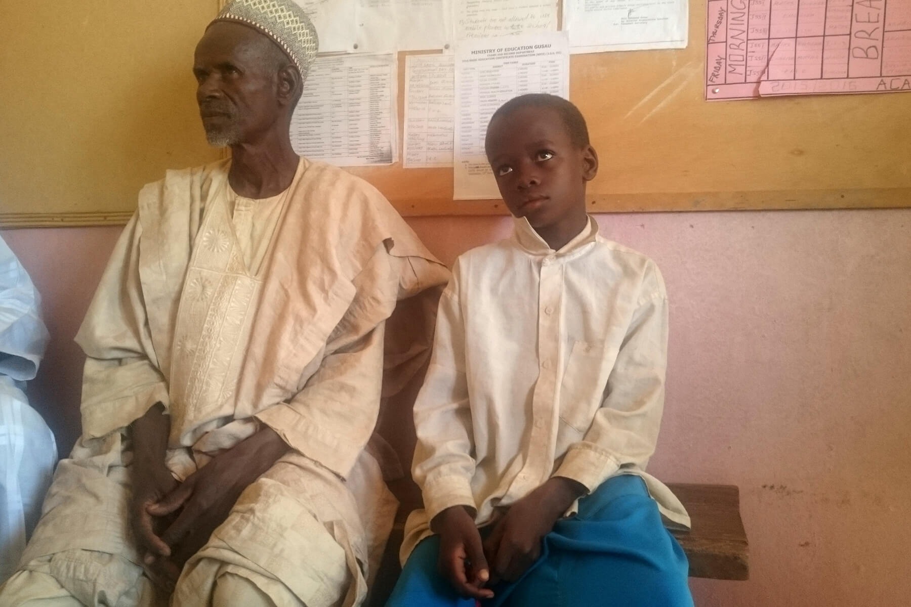 Aliyu sits with his father