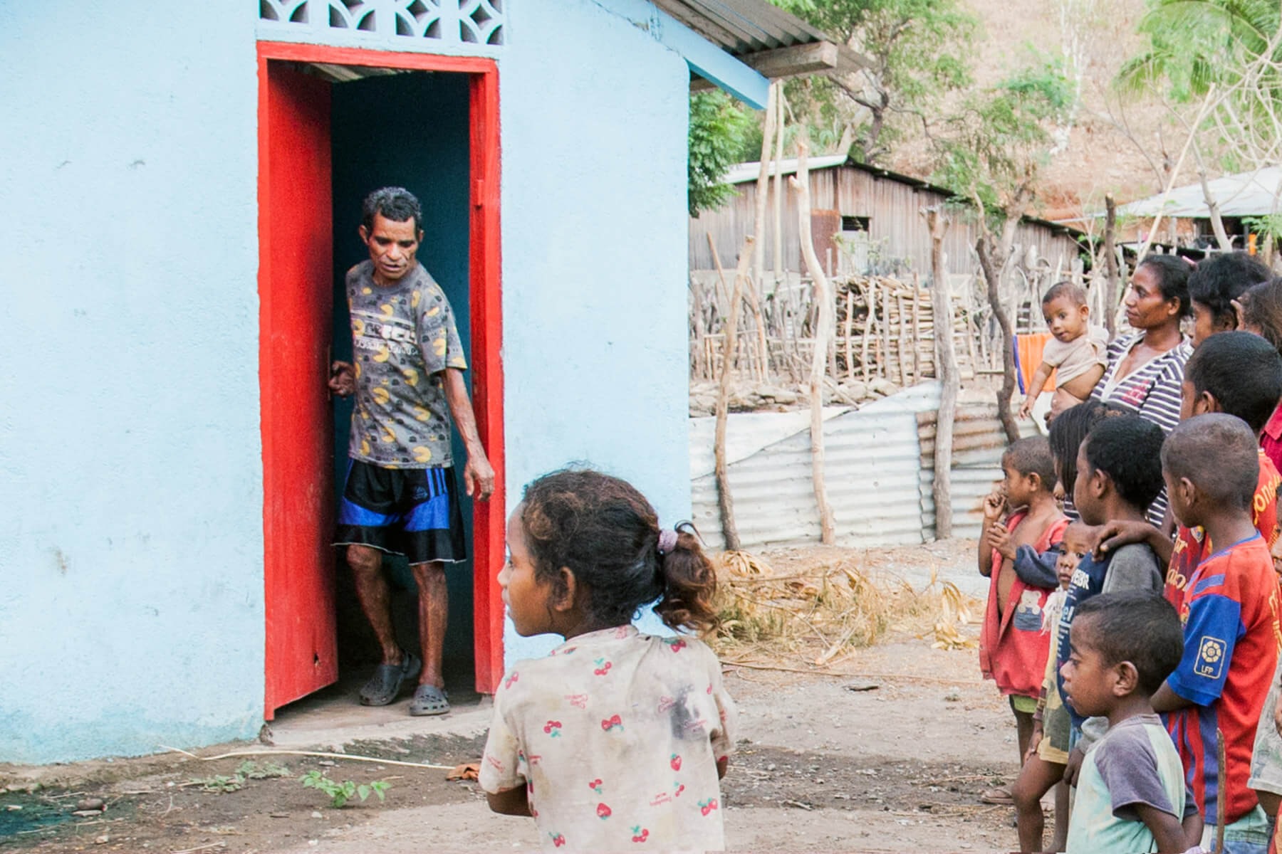 A small crowd gathers to see the new toilet your gifts constructed in Timor Leste